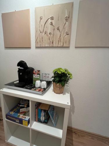 a white table with a plant on top of it at Appartement Seehof in Nassereith
