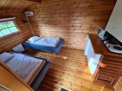 an overhead view of a bedroom in a log cabin at Camp Dammån in Hallen
