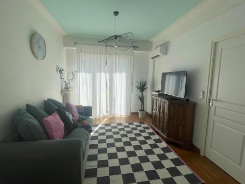 a living room with a couch and a checkered floor at The cozy apartment in heart of the Nice 1km to sea in Nice
