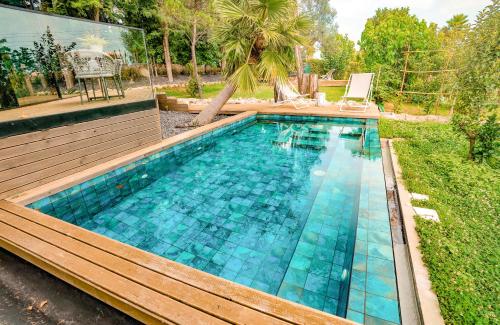 a swimming pool with blue tiles in a backyard at Quinta de Silvalde in Santo Tirso