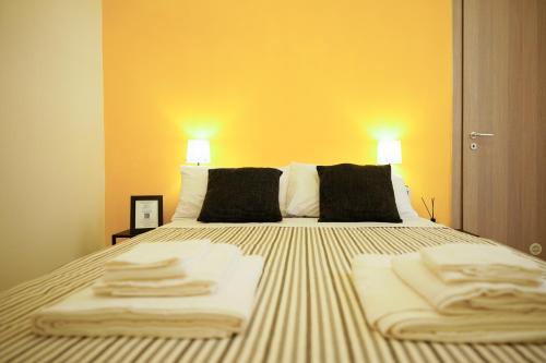 a bedroom with a bed with towels on it at From Home to Vesuvius - Close to Pompeii, Herculaneum, and the Heart of Naples in Torre del Greco