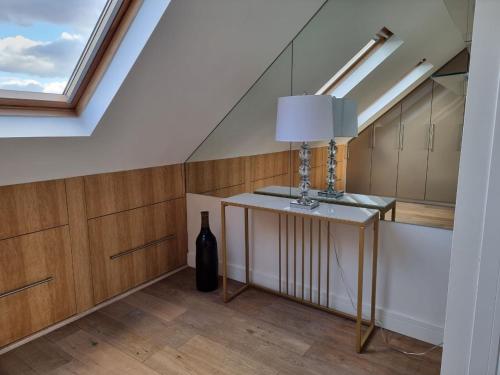 a room with a bottle of wine and a window at Luxury 4 bedroom house in Mill Hill in Mill Hill