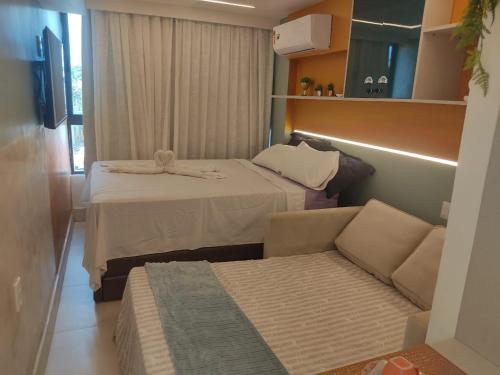 a small room with a bed and a couch at Luar Porto de Galinhas in Porto De Galinhas