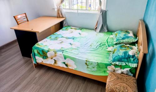 a small bedroom with a bed and a desk at Residential House 3 Bedroom, 1 Bathroom Entire unit in Beau Bassin in Beau Bassin