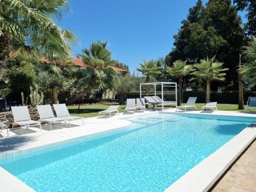 a swimming pool with lounge chairs and a swimming pool at Quinta de Silvalde in Santo Tirso