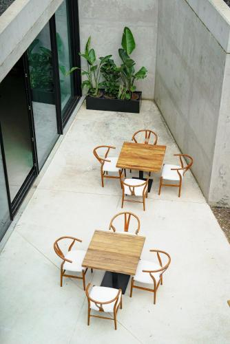 a patio with two wooden tables and chairs at Quinta de Silvalde in Santo Tirso
