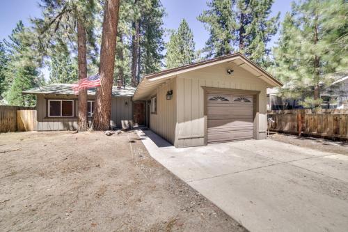 a house with a garage with a flag on it at half Mi to Lake Tahoe Pet-Friendly Cabin in South Lake Tahoe