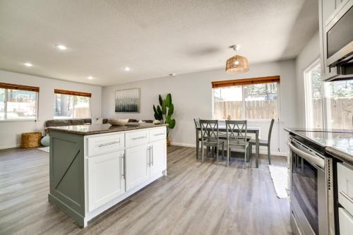 a kitchen with white cabinets and a dining room at half Mi to Lake Tahoe Pet-Friendly Cabin in South Lake Tahoe