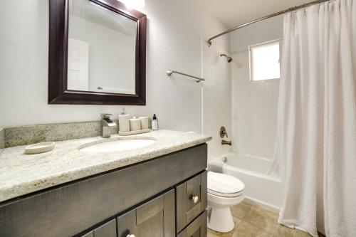 a bathroom with a sink and a toilet and a mirror at Pet-Friendly South Lake Tahoe Vacation Rental! in South Lake Tahoe