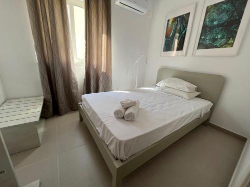 a bedroom with a bed with towels on it at Modern and Spacious 3 Bedroom Apartment in Pembroke