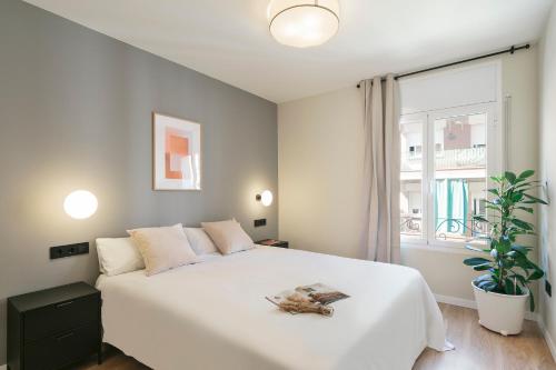 a bedroom with a large white bed and a window at WOW Apartments by Olala Homes in El Arrabal