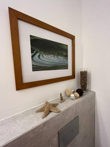 a picture hanging on a wall above a fireplace at Simply with love-haifa in Haifa