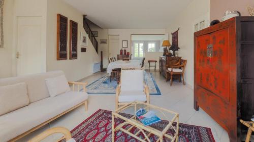 a living room with a couch and a table at Maison Saloine in Saintes