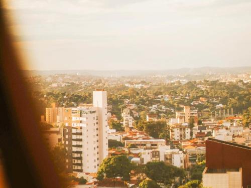 a city view of a city with tall buildings at Éden Pampulha - Hotel Coworking in Belo Horizonte