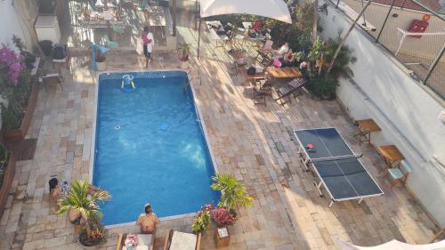 an overhead view of a swimming pool in a building at Éden Pampulha - Hotel Coworking in Belo Horizonte