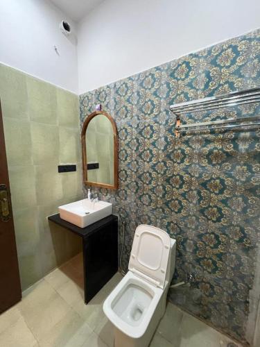 a bathroom with a toilet and a sink at Hotel Desert Pride in Jaisalmer