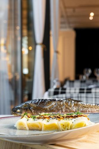 a plate of fish sitting on a table at Hotel Le Place d'Armes - Relais & Châteaux in Luxembourg