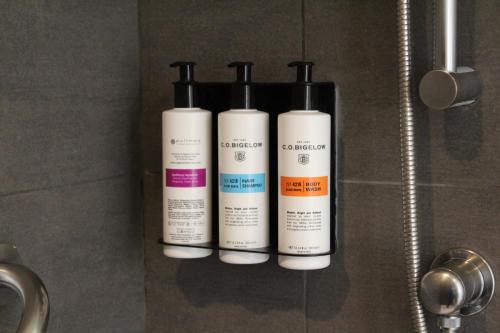 three bottles of moisturizers are sitting on a wall at Pullman Vina del Mar San Martin in Viña del Mar