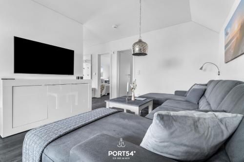 a living room with a couch and a flat screen tv at Ostseeloft in Olpenitz
