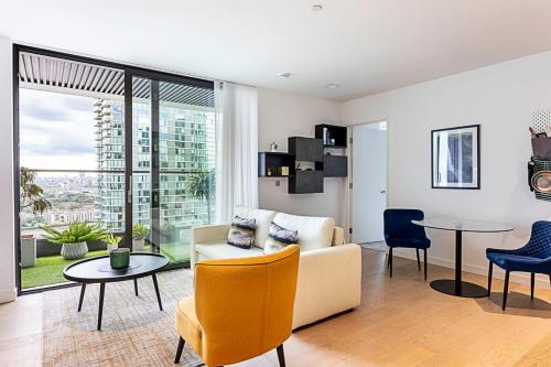 a living room with a couch and a table at Canary Wharf City Escape 1-Bed Apartment in London