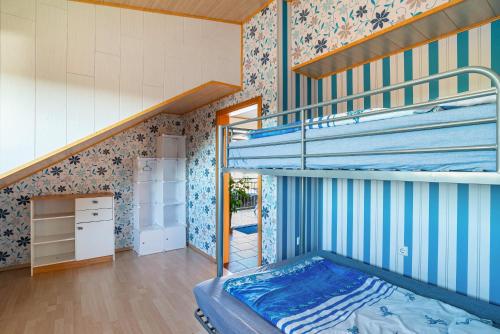 a bedroom with a bunk bed and a staircase at Hügelblick Oase in Kraichtal