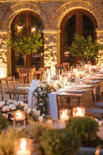 a row of tables with candles in a building at Blerina's Agritourism Concept in Laknas