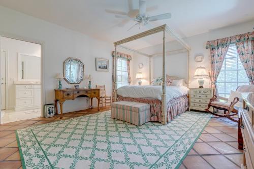 a bedroom with a canopy bed and a rug at Indian Harbor Haven in Vero Beach