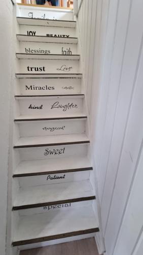 a set of stairs with words on them at The Cozy red house with Amazing sea view in Morskranes