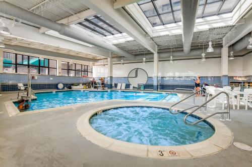 a large swimming pool with blue water in a building at Sea Colony---1805 Doubles Court in Bethany Beach