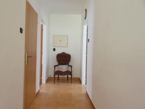 a hallway with a chair in a room at Chalupa Pěkný den in Rudník
