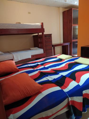 a bedroom with two beds with a colorful blanket at Sun Havens Apartments & Suites in Bocas del Toro