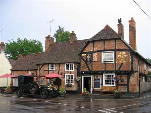 a black truck parked in front of a building at The Plume of Feathers in Farnham