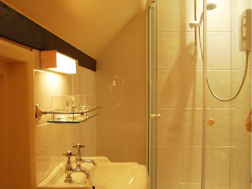 a bathroom with a shower and a sink at The Plume of Feathers in Farnham