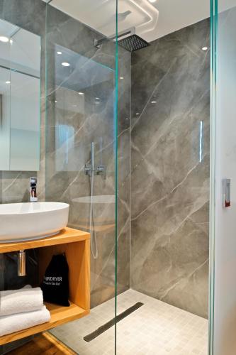 a bathroom with a shower and a sink at HOTEL SAINT ROCH in Ogliastro
