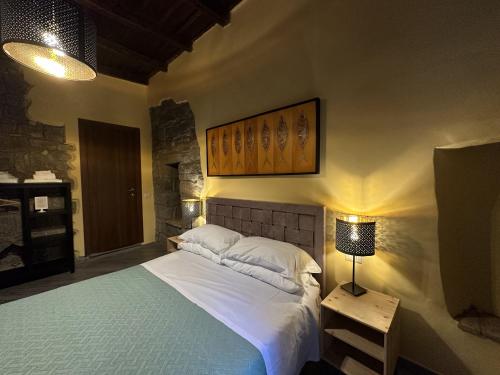 a bedroom with a bed and a table with a lamp at Al Cardinale in Viterbo