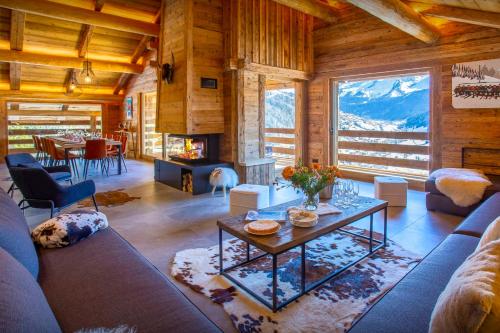 ein Wohnzimmer mit einem Sofa und einem Tisch in der Unterkunft Chalet Happyview - OVO Network in Le Grand-Bornand