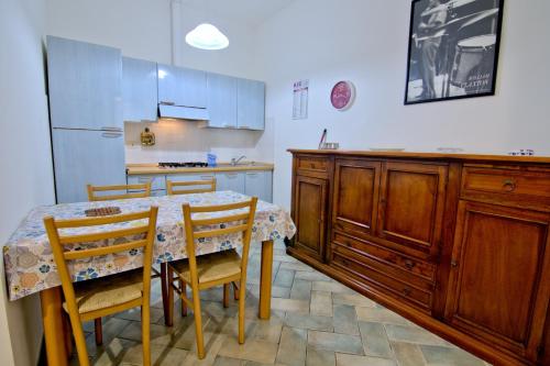 a kitchen with a table and chairs and a refrigerator at Villa Very in Marina di Campo