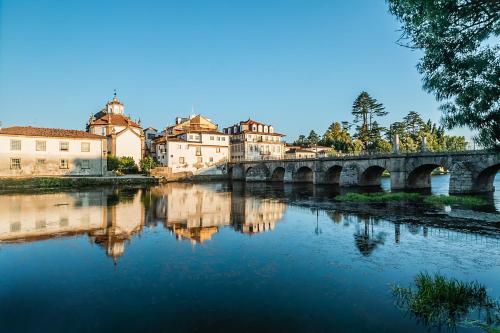 a bridge over a river in a city with buildings at ibis Styles Chaves in Chaves
