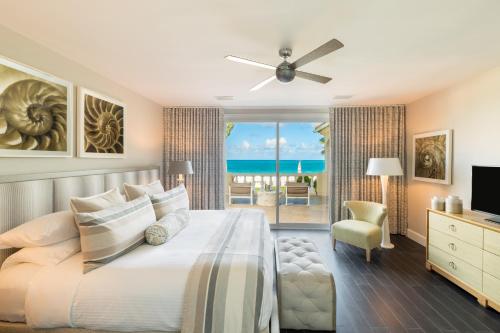 a bedroom with a bed and a view of the ocean at Grace Bay Club in Grace Bay