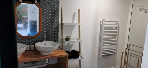 a bathroom with a white sink and a mirror at Le Spot Blériot-Plage gîte de groupe proche mer in Sangatte