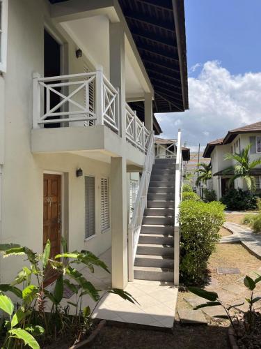 a stairway leading up to a white house at Finest Accommodation Renfrew Place 1 Bedroom Apt # 42 New Kgn 4--12 Renfrew Rd in Kingston