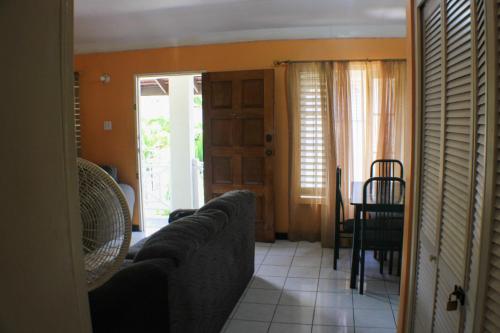 a living room with a couch and a table at Finest Accommodation Renfrew Place 1 Bedroom Apt # 42 New Kgn 4--12 Renfrew Rd in Kingston