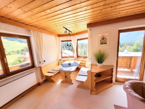 a small room with a table and some windows at Schickster Sky Lodge in Leutasch