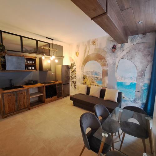 a living room with a couch and a table and chairs at CAIETA Housing in Gaeta