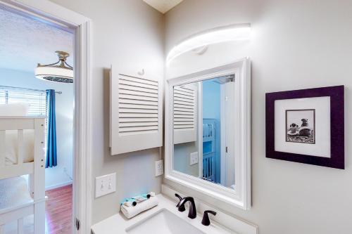 a white bathroom with a sink and a mirror at Gulf Highlands - 238 Saint Katherine in Panama City Beach