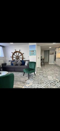 a living room with a bed and a green couch at The Captains Wheel and Anchor in Skerries