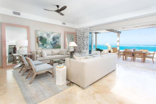 a living room with a couch and chairs and a table at Grace Bay Club in Grace Bay