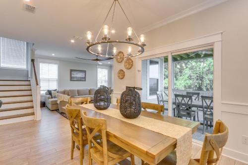 a dining room and living room with a table and chairs at 3 Decks and Water Views Breezy Home in Hilton Head in Hilton Head Island
