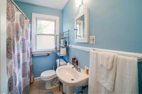 a blue bathroom with a toilet and a sink at Spacious Ferndale Apt with Yard about half Mi to Dtwn! in Ferndale