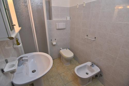 a bathroom with a sink and a toilet at Villa Very in Marina di Campo